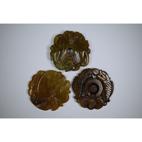 294 - A Chinese carved nephrite jade or other hardstone twin fish amulet, to/w another fish carved amulet ... 