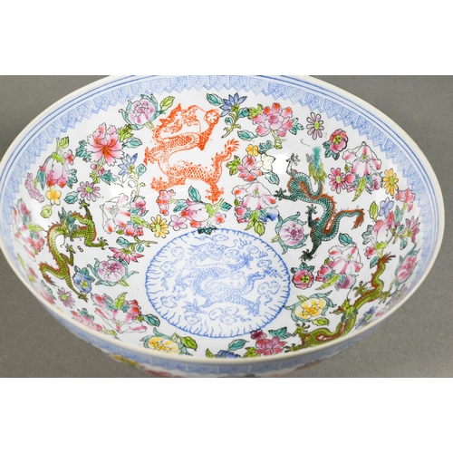 297 - A 20th century Chinese eggshell porcelain polychrome bowl decorated with dragons and flowers, the ba... 