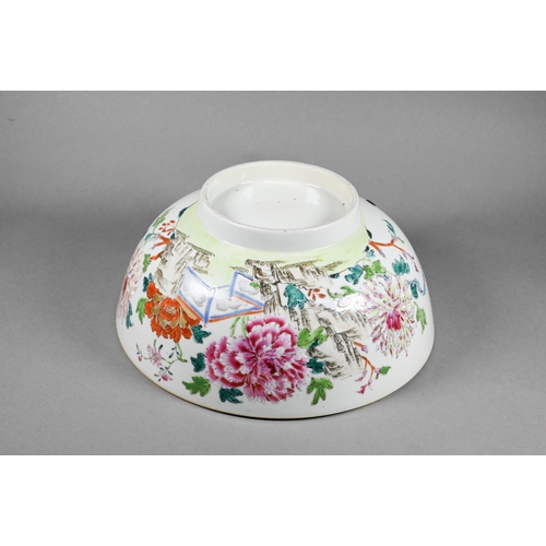 298 - An 18th century Chinese famille rose punch bowl painted with large blossoming peonies in a fenced ga... 