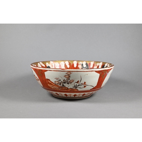 298 - An 18th century Chinese famille rose punch bowl painted with large blossoming peonies in a fenced ga... 