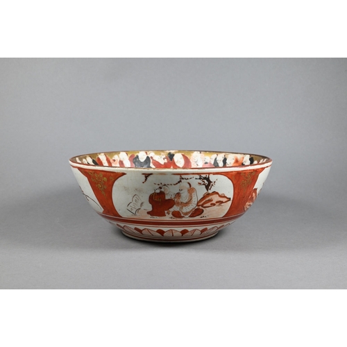 298 - An 18th century Chinese famille rose punch bowl painted with large blossoming peonies in a fenced ga... 