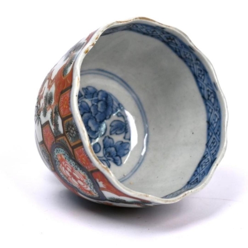 299 - A 19th century Japanese Arita floriform tea bowl, painted in underglaze blue and polychrome Imari pa... 