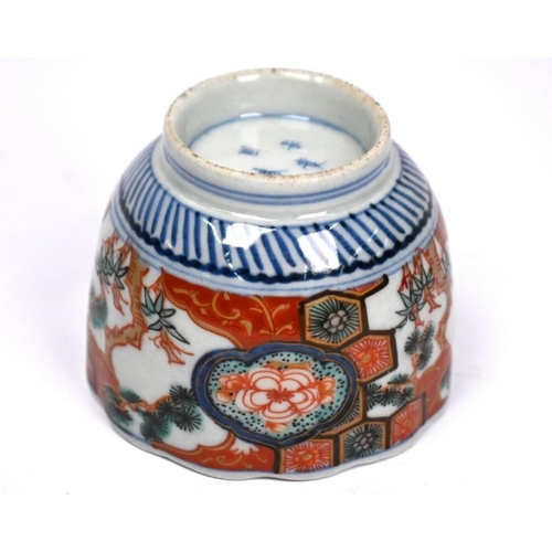 299 - A 19th century Japanese Arita floriform tea bowl, painted in underglaze blue and polychrome Imari pa... 