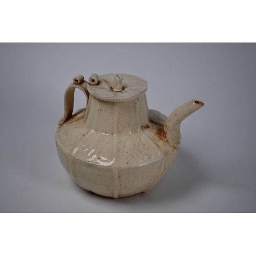 303 - A Chinese Northern Song style teapot and cover with crackled cream-glaze and relief decoration, 20th... 