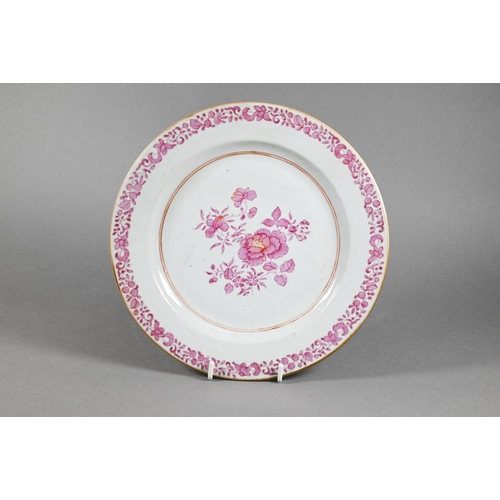 311 - An 18th century Chinese famille rose plate painted in puce enamels with peonies within an iron red a... 