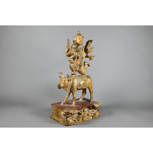 315 - A 20th century Thai gilded bronze of the Hindu deity Shiva on the Nandi Bull, his ten flailing arms ... 