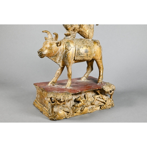 315 - A 20th century Thai gilded bronze of the Hindu deity Shiva on the Nandi Bull, his ten flailing arms ... 