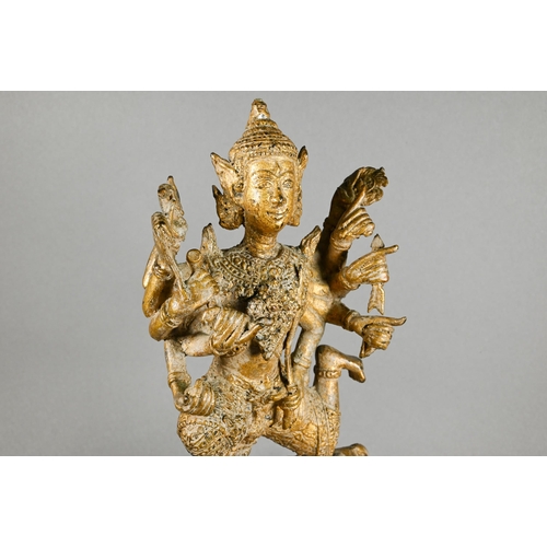 315 - A 20th century Thai gilded bronze of the Hindu deity Shiva on the Nandi Bull, his ten flailing arms ... 