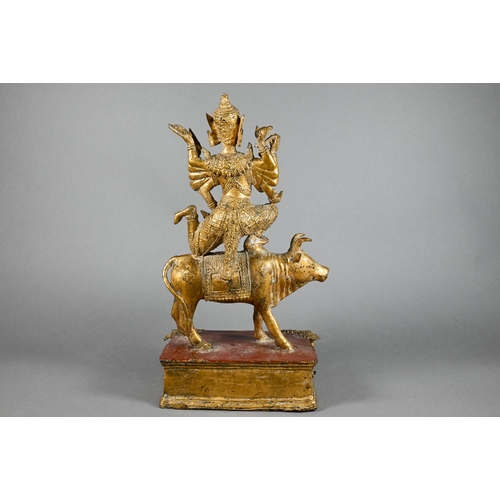 315 - A 20th century Thai gilded bronze of the Hindu deity Shiva on the Nandi Bull, his ten flailing arms ... 