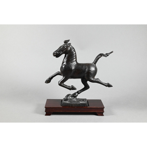 319 - A 20th century Chinese bronze replica figure of 'The Flying Horse of Gansu' modeled with one hoof re... 