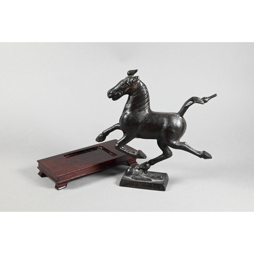 319 - A 20th century Chinese bronze replica figure of 'The Flying Horse of Gansu' modeled with one hoof re... 