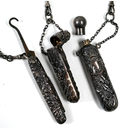 32 - A Victorian silver chatelaine of ornately-pierced scroll and foliage design surmounted by gryphons, ... 
