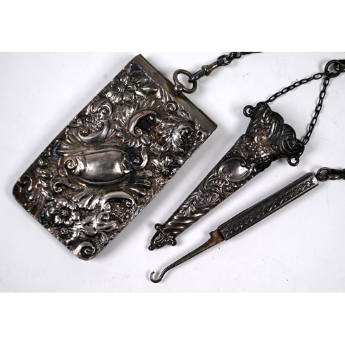 32 - A Victorian silver chatelaine of ornately-pierced scroll and foliage design surmounted by gryphons, ... 