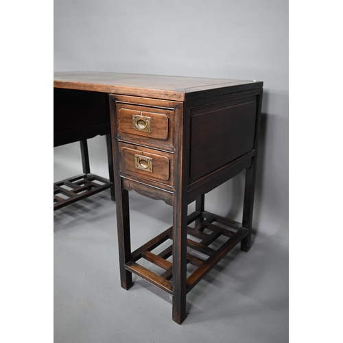 327 - An antique Chinese hardwood three section desk, the floating single panel top over twin drawers to e... 