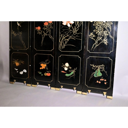 327A - An early 20th century Chinese lacquered four panel screen painted and gilded with idyllic landscapes... 