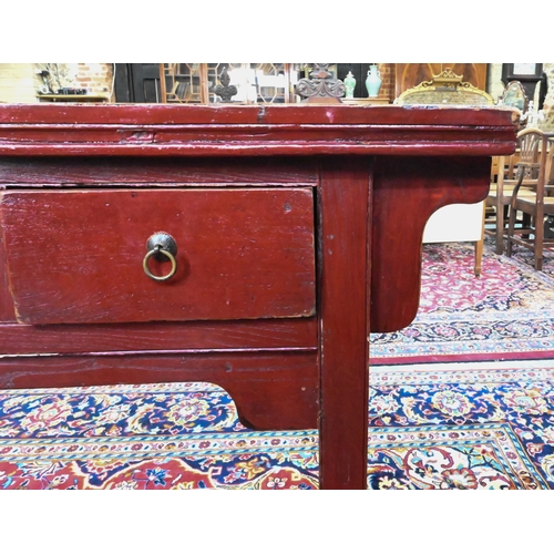 330 - An antique Chinese red lacquer four drawer side table / altar table, raised on square section legs, ... 