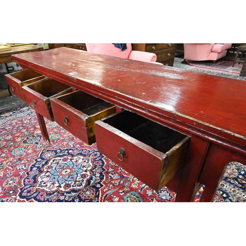 330 - An antique Chinese red lacquer four drawer side table / altar table, raised on square section legs, ... 