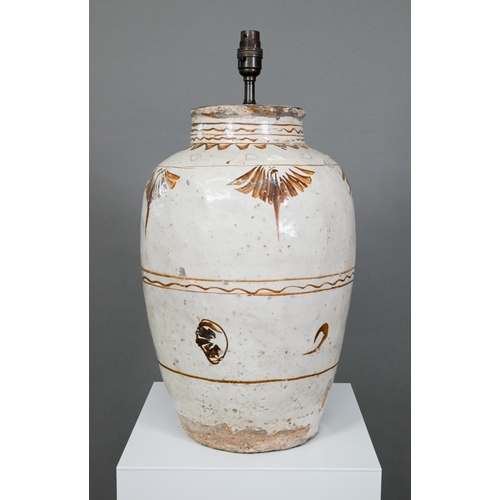 337 - A large Chinese Cizhou stoneware storage jar, probably Ming dynasty, covered with an ivory slip glaz... 