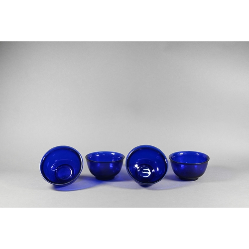 338 - Four Chinese Peking blue glass bowls with slightly everted rim, deep rounded sides and circular foot... 