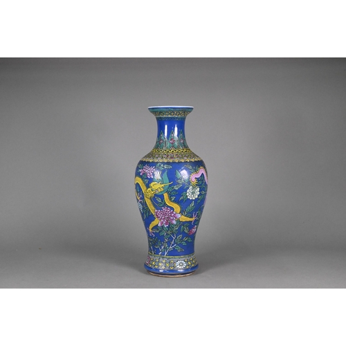 339 - A 19th century Chinese famille rose blue ground baluster vase, painted in polychrome enamels with tw... 