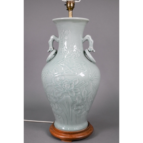 355 - A Chinese celadon vase of baluster form with gnarled prunus branch handles fixed ring handles, the b... 