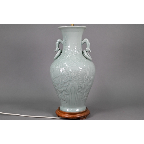 355 - A Chinese celadon vase of baluster form with gnarled prunus branch handles fixed ring handles, the b... 