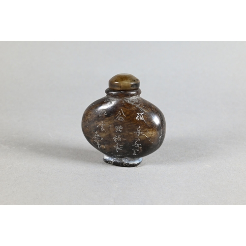 357 - A Chinese hardwood snuff bottle and stopper, stippled and carved in relief with taotie mask decorati... 