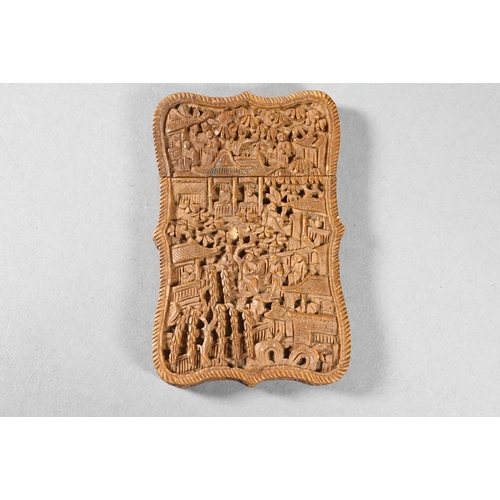 359 - A 19th century Chinese Canton sandalwood card case profusely carved with a village scene, dwellings ... 