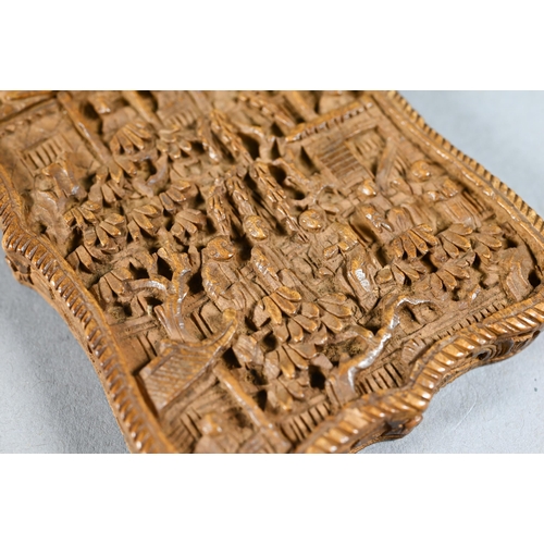 359 - A 19th century Chinese Canton sandalwood card case profusely carved with a village scene, dwellings ... 