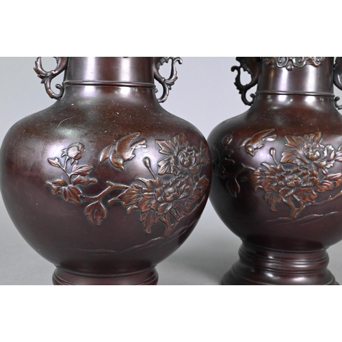 365 - A pair of late 19th or early 20th century Japanese bronze vases, the flaring necks with archaistic d... 