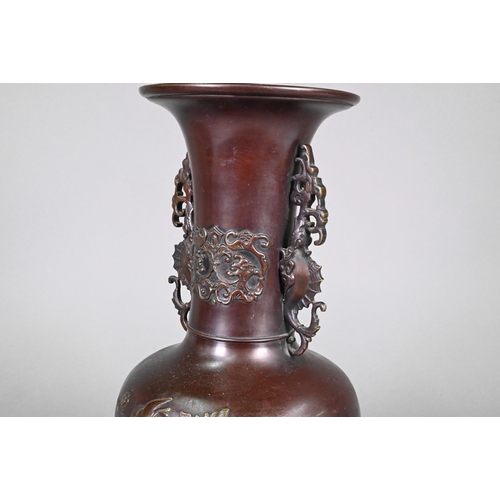 365 - A pair of late 19th or early 20th century Japanese bronze vases, the flaring necks with archaistic d... 