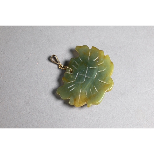 378 - A Chinese pale celadon pendant carved with two playing cups on a leaf, 6 cm wide with smaller squirr... 