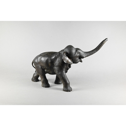 384 - A Japanese Meiji period (1868-1912) bronze elephant, modelled striding forward with raised trunk, si... 