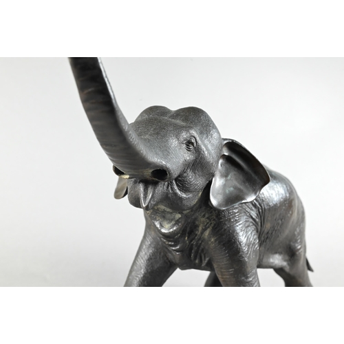 384 - A Japanese Meiji period (1868-1912) bronze elephant, modelled striding forward with raised trunk, si... 