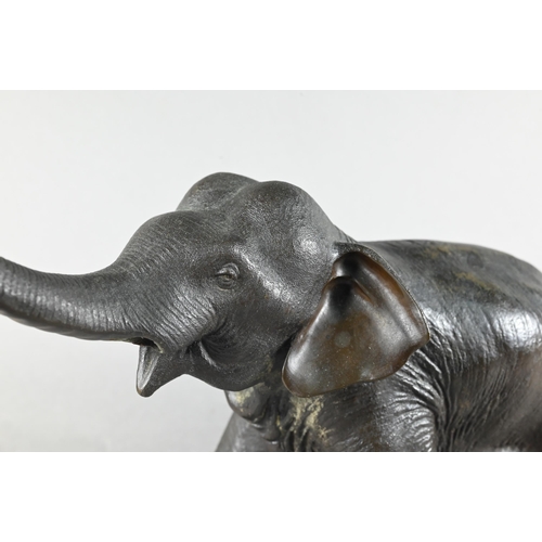 384 - A Japanese Meiji period (1868-1912) bronze elephant, modelled striding forward with raised trunk, si... 