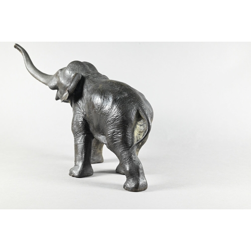 384 - A Japanese Meiji period (1868-1912) bronze elephant, modelled striding forward with raised trunk, si... 