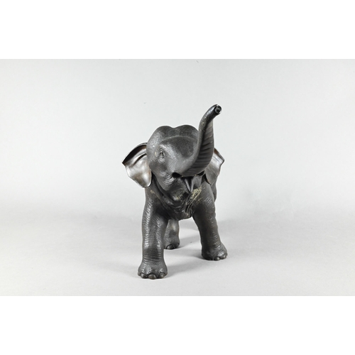 384 - A Japanese Meiji period (1868-1912) bronze elephant, modelled striding forward with raised trunk, si... 