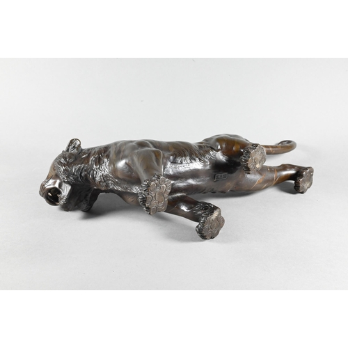 384A - A Japanese Meiji period (1868-1912) bronze prowling tiger signed by Seiya, 35 cm wide to/w a similar... 