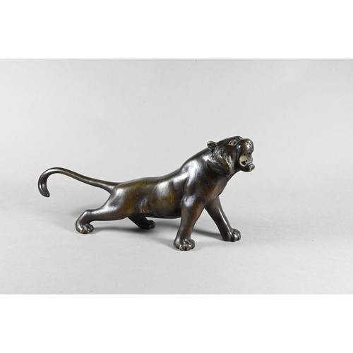 384A - A Japanese Meiji period (1868-1912) bronze prowling tiger signed by Seiya, 35 cm wide to/w a similar... 