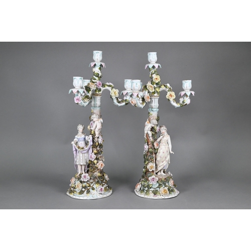 386 - A pair of Sitzendorf porcelain floral-encrusted candelabra with detachable three branch tops, the ba... 