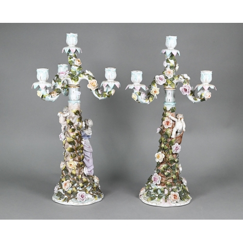 386 - A pair of Sitzendorf porcelain floral-encrusted candelabra with detachable three branch tops, the ba... 