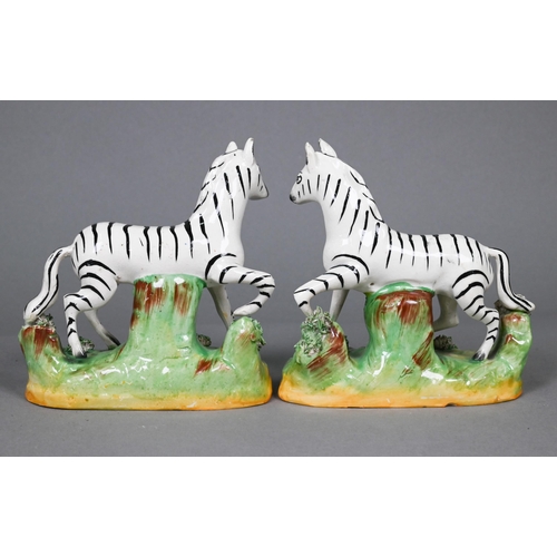 395 - A pair of 19th century Staffordshire pottery zebras, 13 cm high