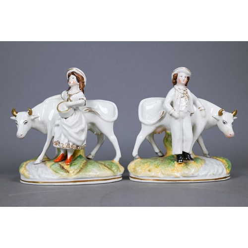 396 - Pair of Victorian Staffordshire pottery groups, figures with cows, 17 cm high