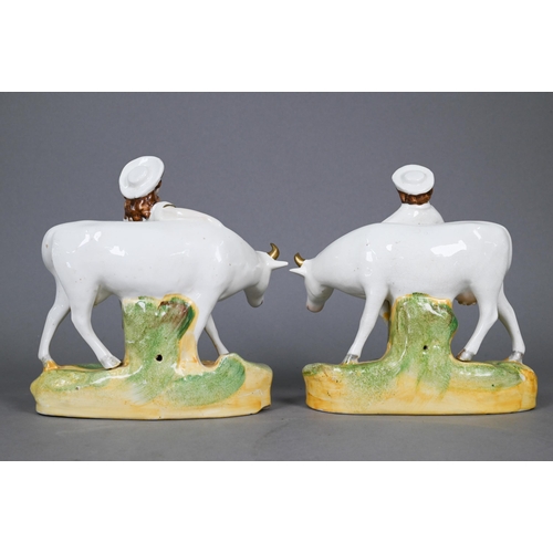 396 - Pair of Victorian Staffordshire pottery groups, figures with cows, 17 cm high