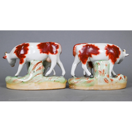 397 - Pair of 19th century Staffordshire pottery cows with calves, 10 cm high