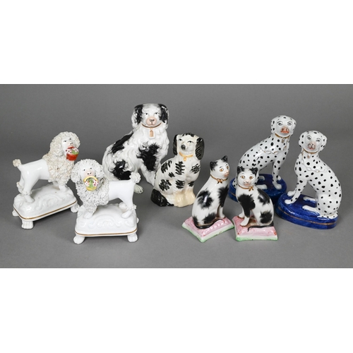 398 - Pair of Staffordshire pottery dalmatians, 13 cm high; a pair of poodles holding baskets of flowers i... 