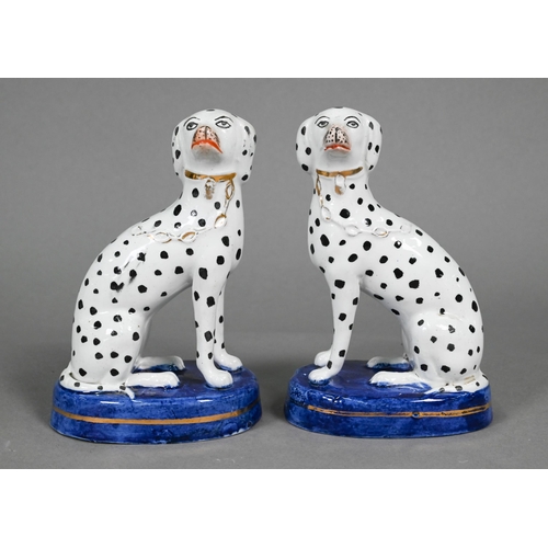 398 - Pair of Staffordshire pottery dalmatians, 13 cm high; a pair of poodles holding baskets of flowers i... 