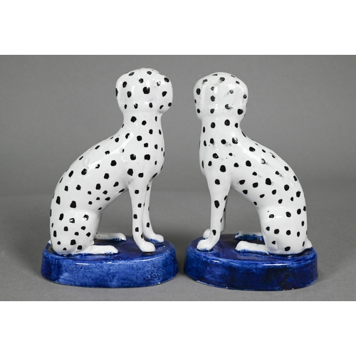 398 - Pair of Staffordshire pottery dalmatians, 13 cm high; a pair of poodles holding baskets of flowers i... 