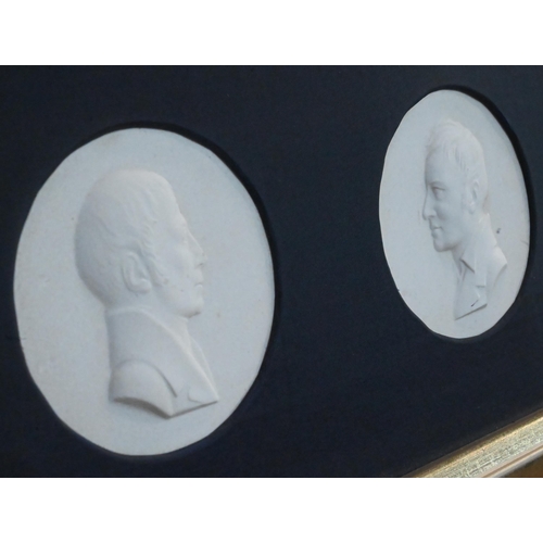 407 - A framed pair of Berlin porcelain medallions commemorating Wilhelm & Alexander von Humboldt; each pl... 