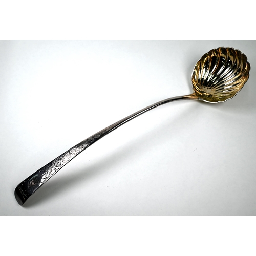 43 - A George II Irish silver punch ladle with shell bowl and floral-engraved Old English Pattern handle,... 